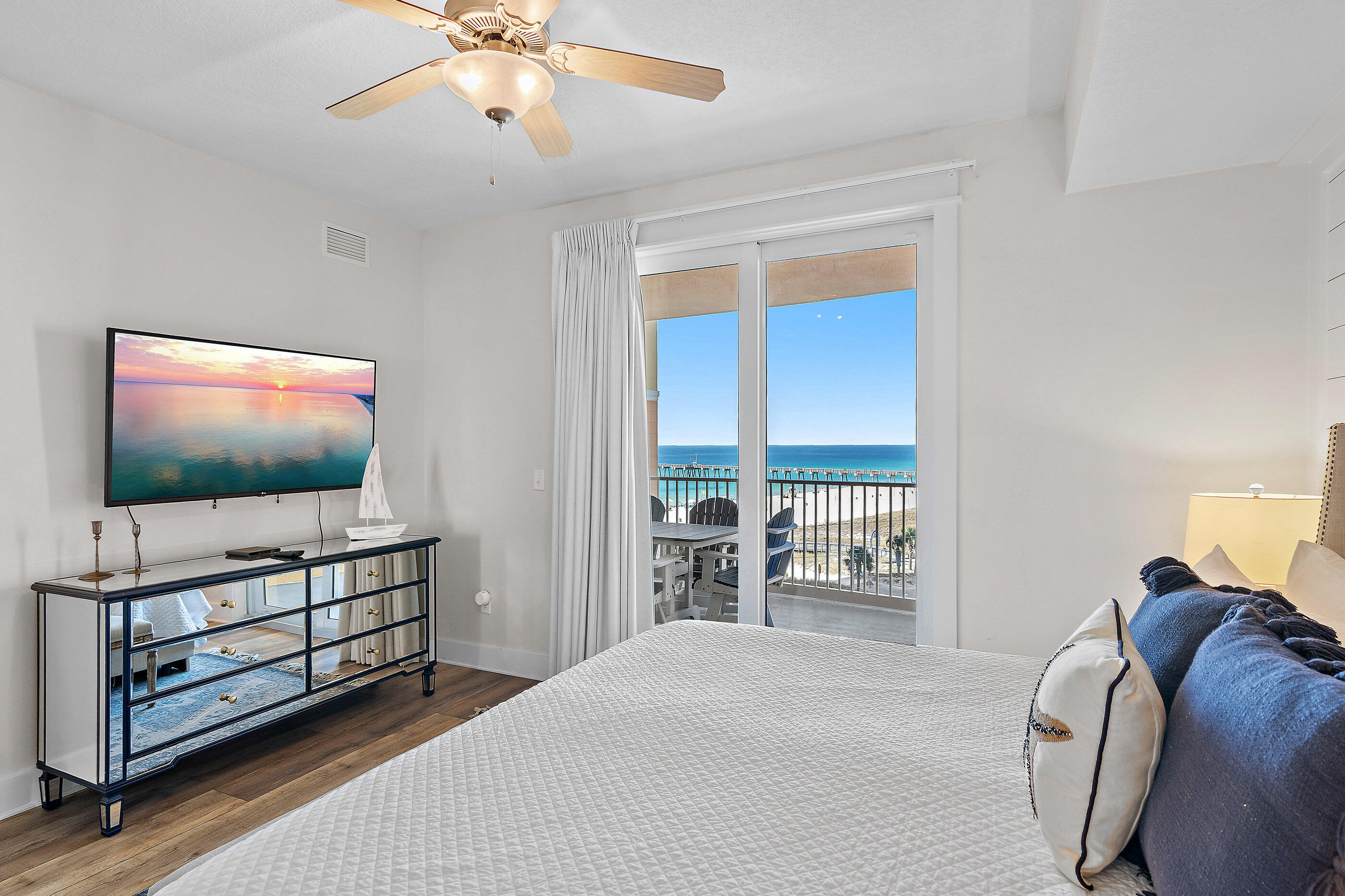 15928 Front Beach Road, Unit 601 Panama City Beach, FL 32413 - Photo 15 of 39 a bedroom with furniture and flat screen tv