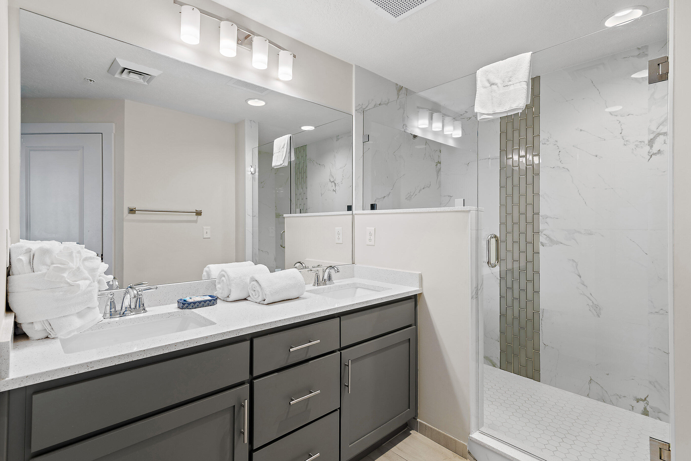 15928 Front Beach Road, Unit 601 Panama City Beach, FL 32413 - Photo 17 of 39 a bathroom with a double vanity sink mirror and shower