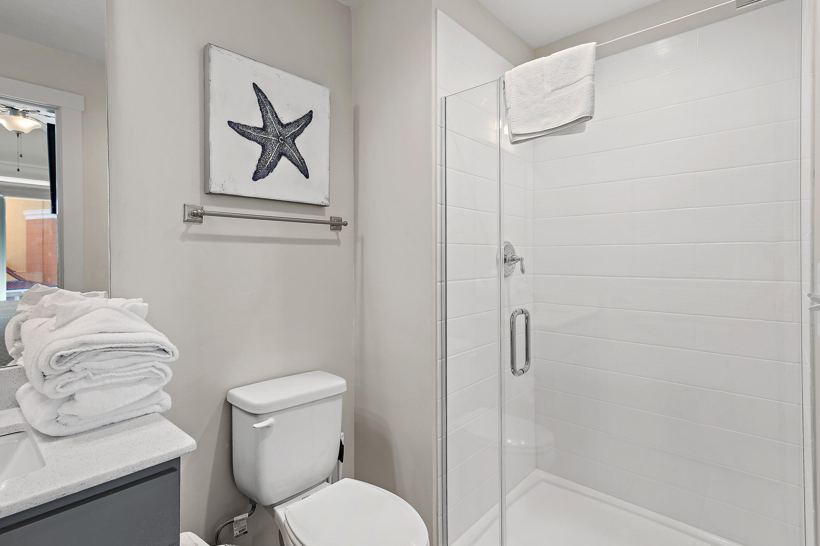 15928 Front Beach Road, Unit 601 Panama City Beach, FL 32413 - Photo 27 of 39 a white toilet sitting next to a bathroom sink