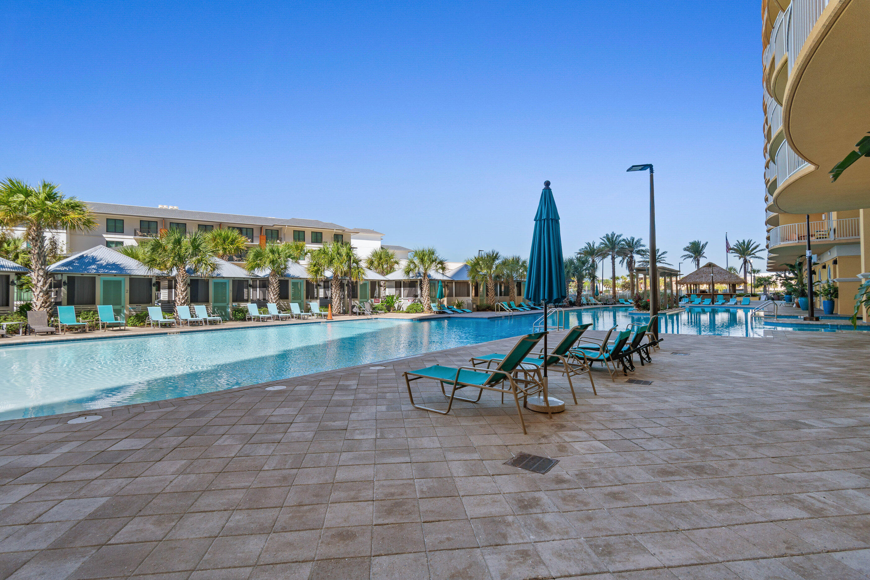 15928 Front Beach Road, Unit 601 Panama City Beach, FL 32413 - Photo 38 of 39 a view of a swimming pool with lawn chairs