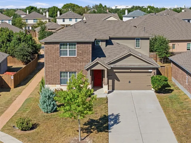 an aerial view of a house with yard
