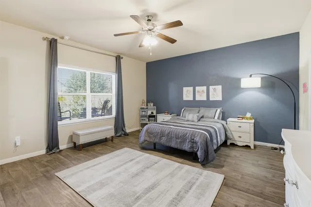a bedroom with a large bed and a window