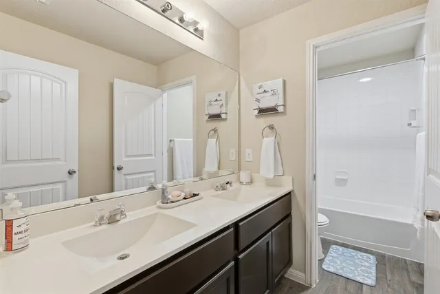 a bathroom with a sink double vanity and a mirror