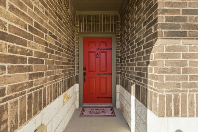 a view of a door and wooden floor