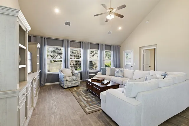 a living room with furniture and large windows