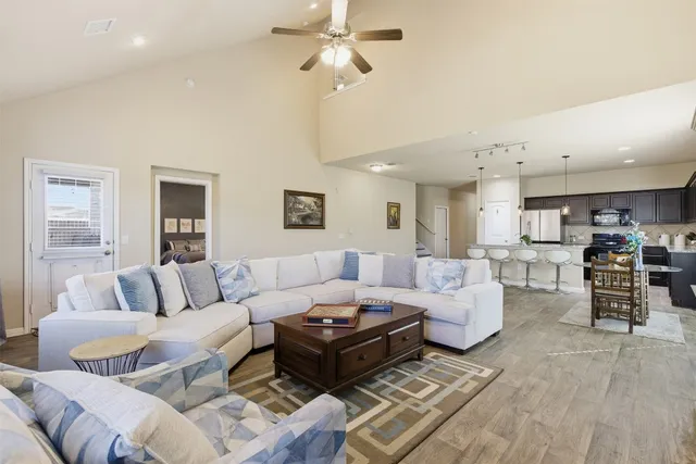 a living room with furniture and wooden floor