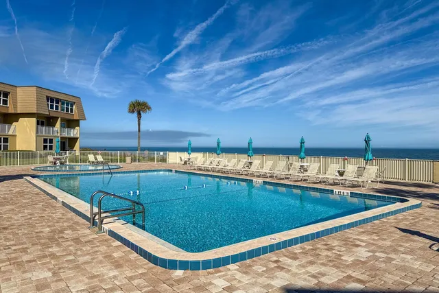 a view of a swimming pool and outdoor kitchen