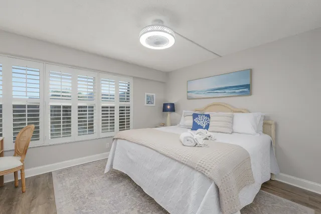 a bedroom with a bed and a large window