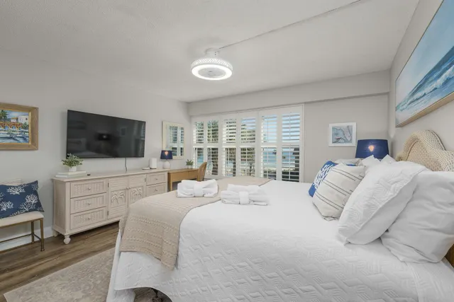 a bedroom with a bed and a flat screen tv