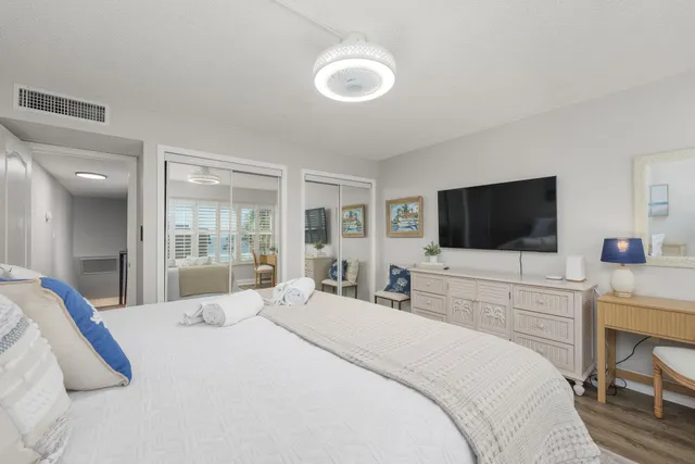 a bedroom with a bed and a flat screen tv