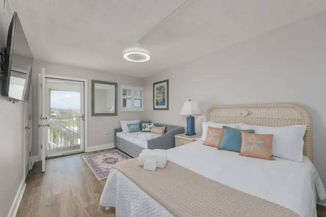 a bedroom with a large bed and a tv