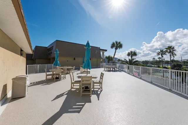 a view of a terrace with furniture and city view