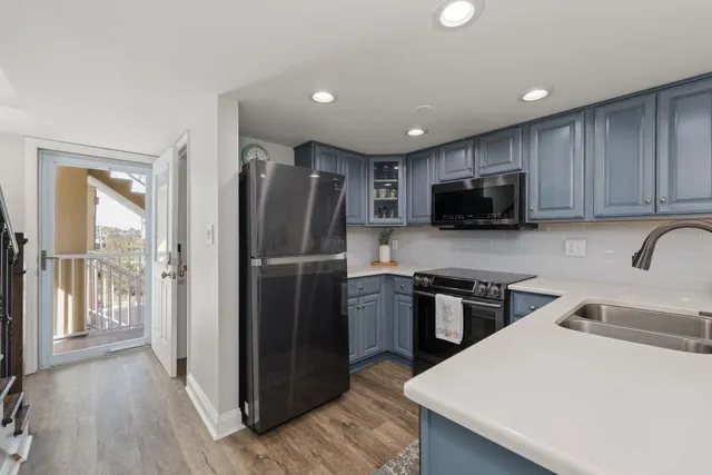 a kitchen with stainless steel appliances granite countertop a refrigerator stove microwave and sink