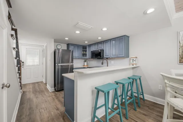 a kitchen with kitchen island wooden cabinets and stainless steel appliances