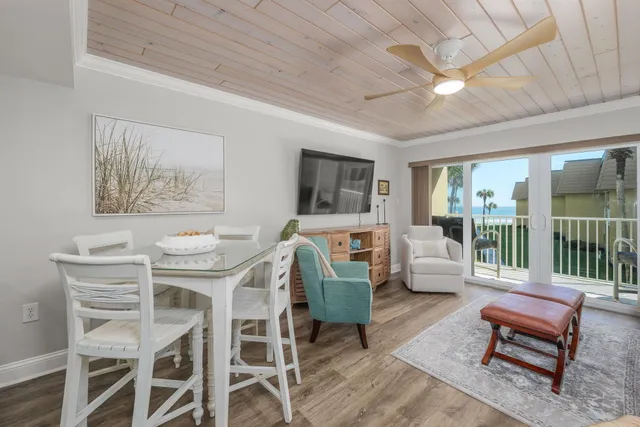 a living room with furniture a flat screen tv and a large window
