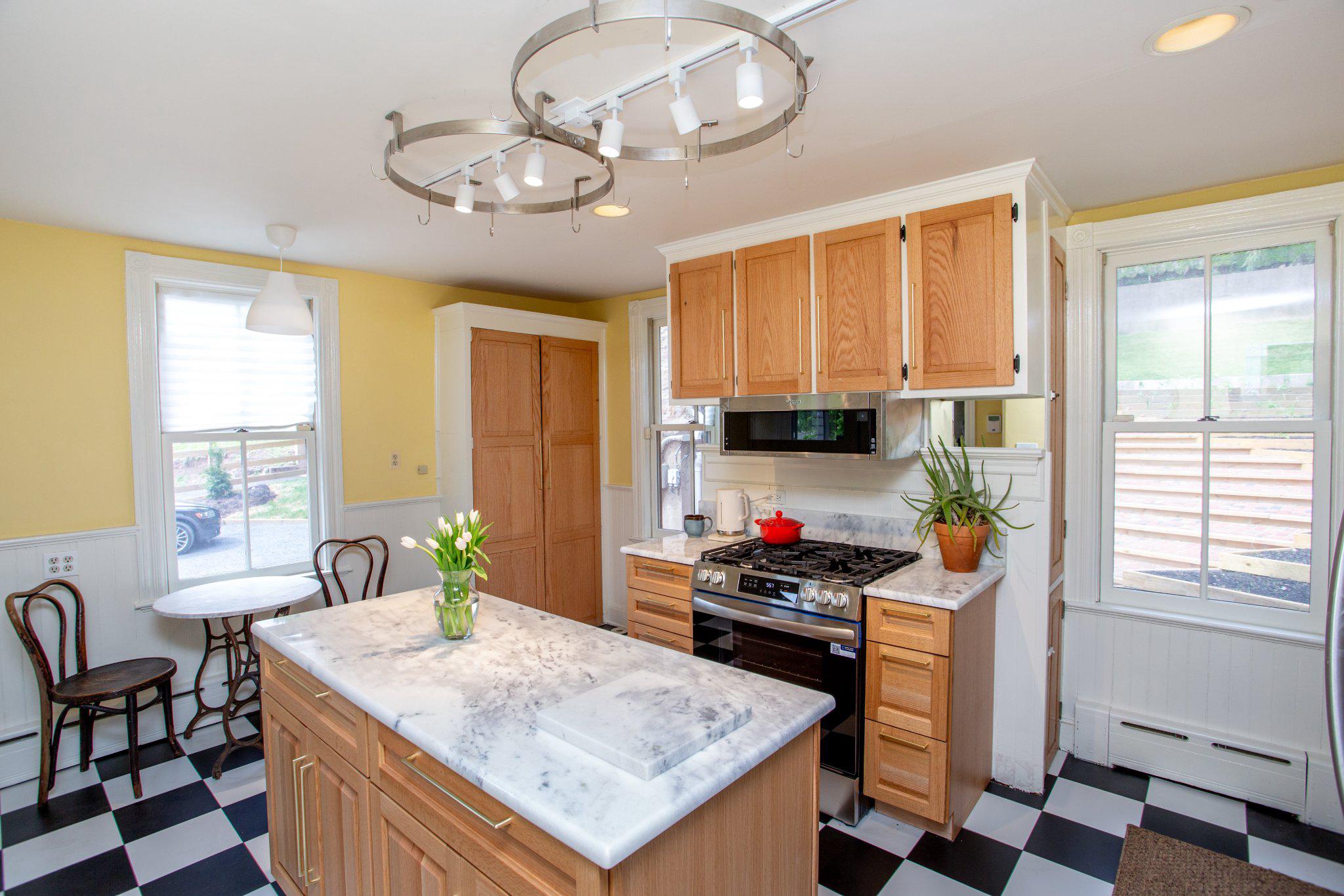 3 South Main Street Stockton, NJ 08559 - Photo 4 of 42 a kitchen with a stove a sink a dining table and chairs