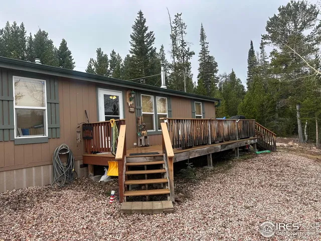 a view of a backyard with a deck and wooden floor