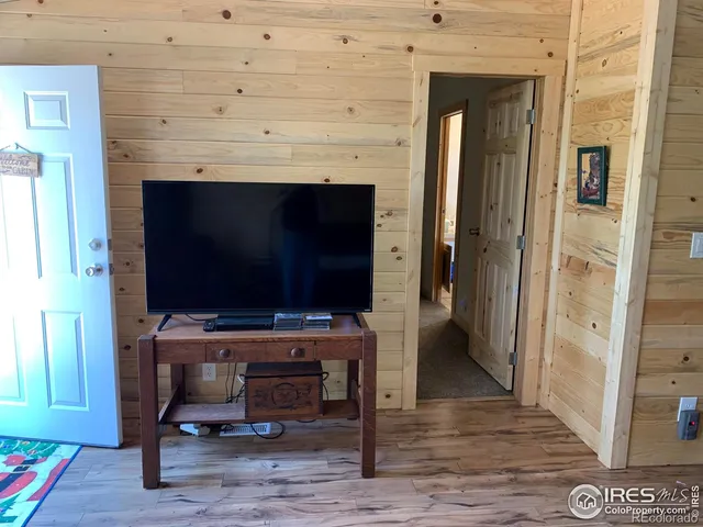 a living room with a flat screen tv a rug and a fireplace