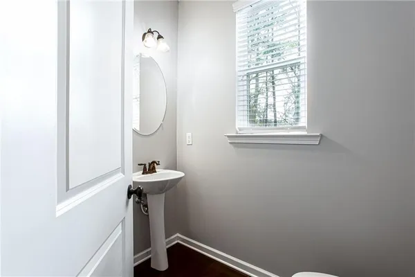 a bathroom with a sink a mirror and a window