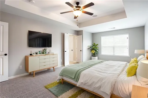 a bedroom with a bed and a flat screen tv
