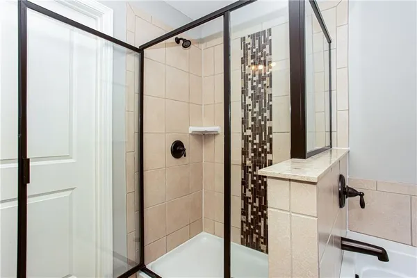 a bathroom with a shower and a sink