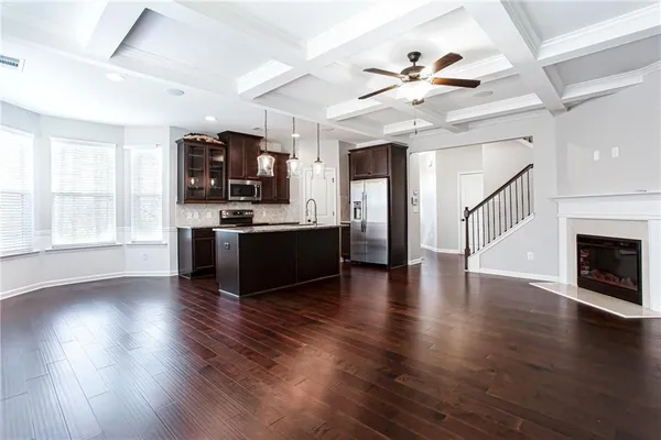 a view of kitchen with sink microwave and stove