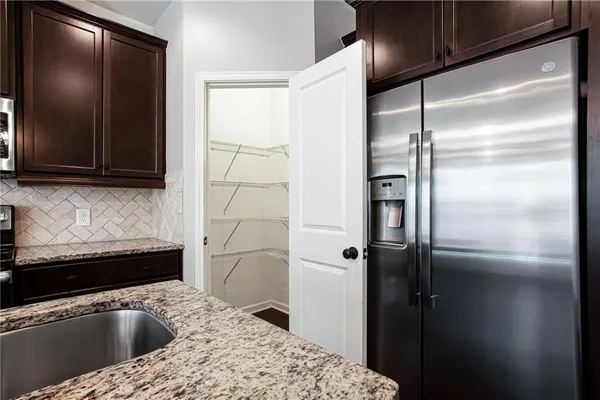a kitchen with a sink and a refrigerator