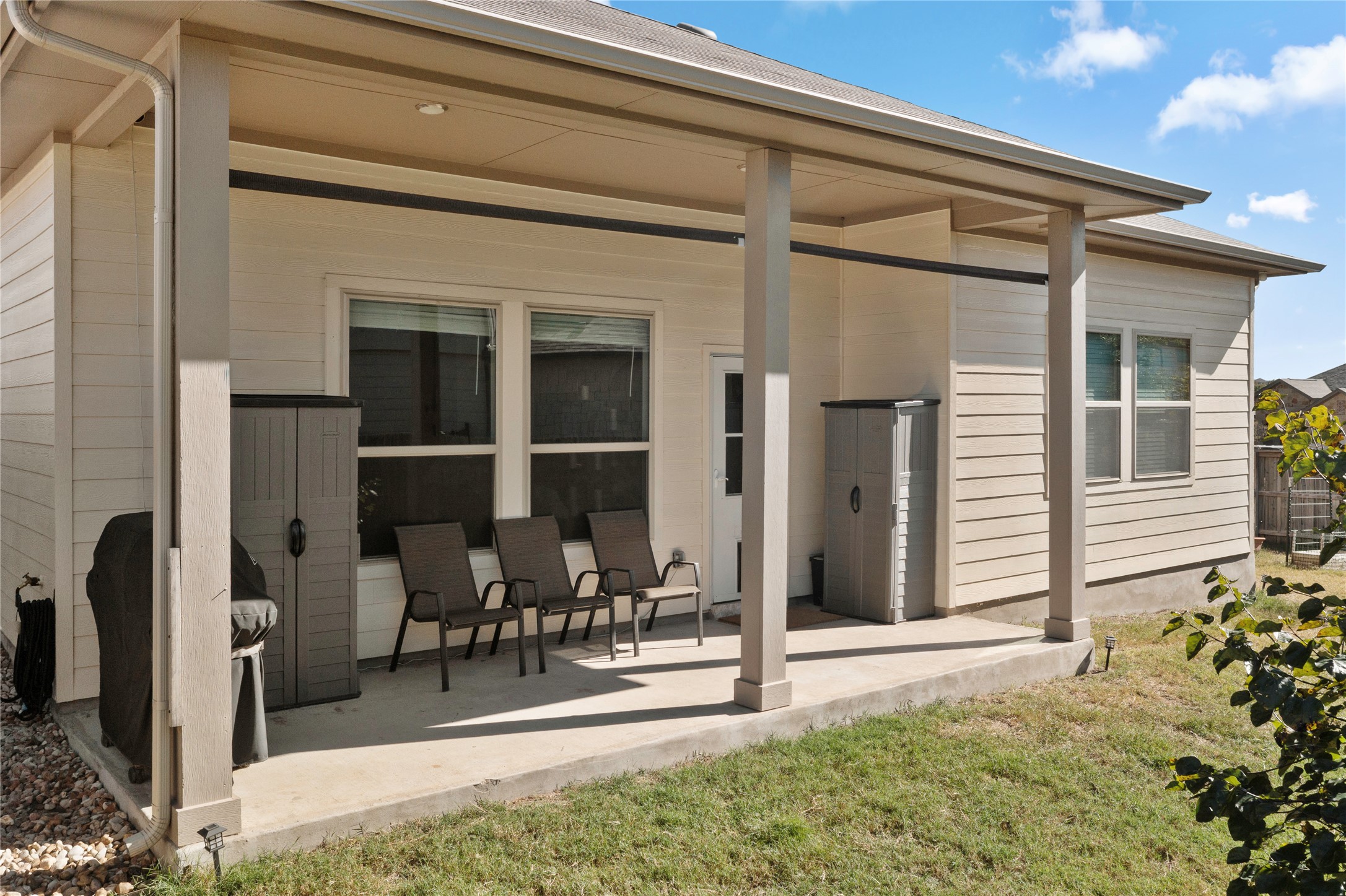 932 Medina Way Leander, TX 78641 - Photo 20 of 28 Back of property featuring a lawn and a patio