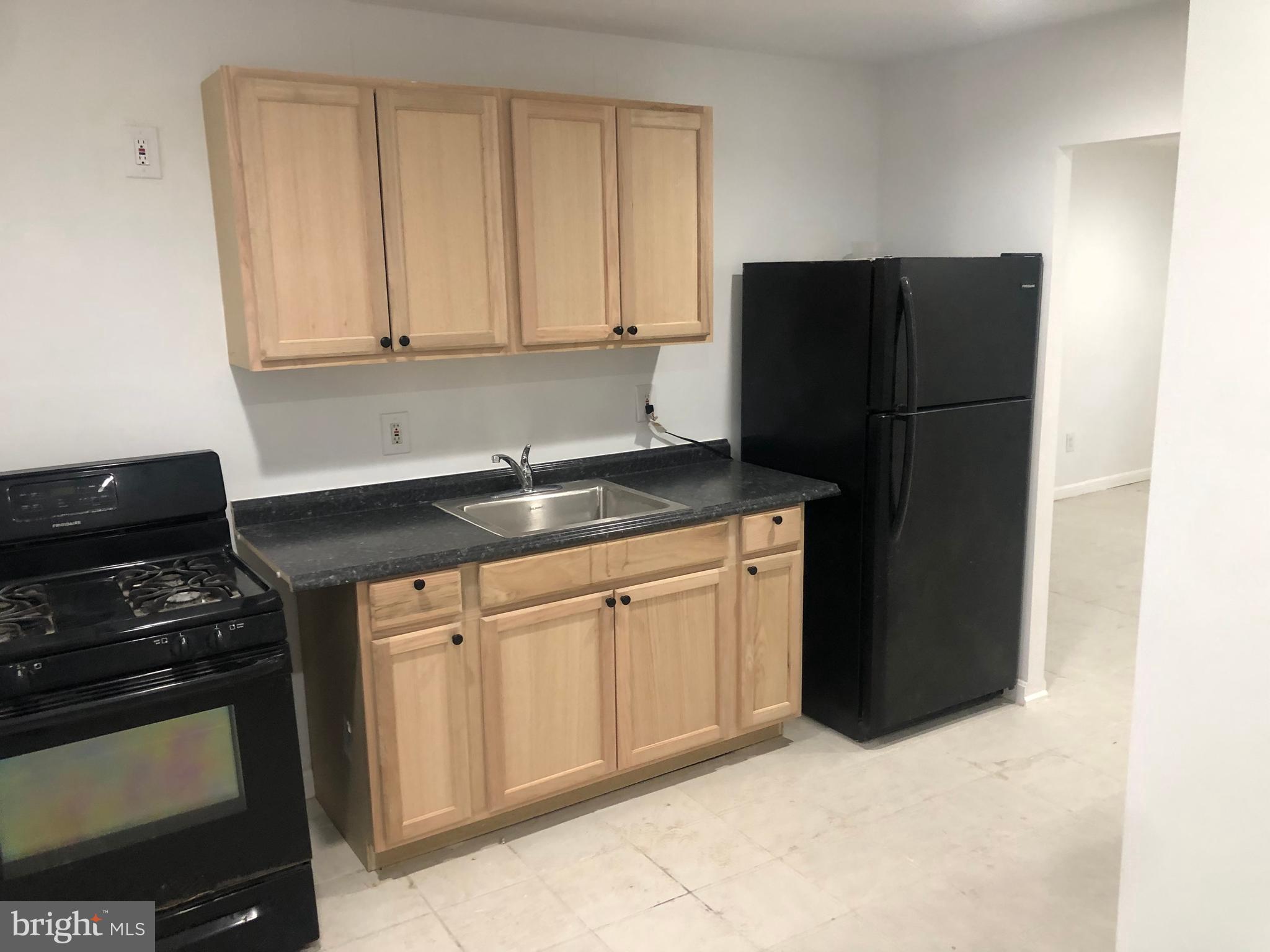 193 Kinsley Road Pemberton, NJ 08068 - Photo 3 of 22 a kitchen with granite countertop white cabinets and refrigerator