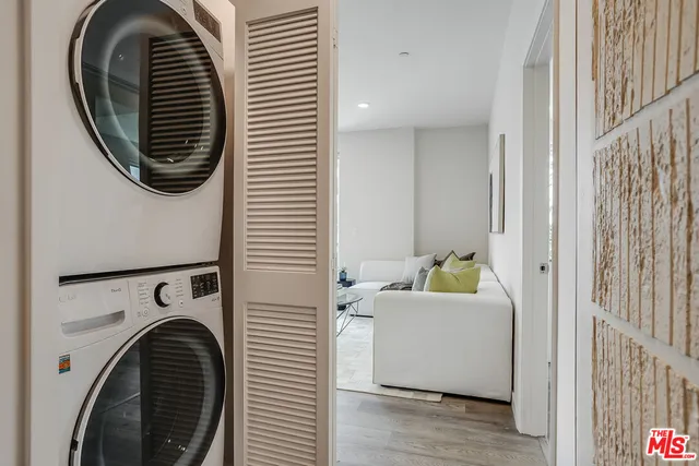 a view of a bedroom with washer and dryer