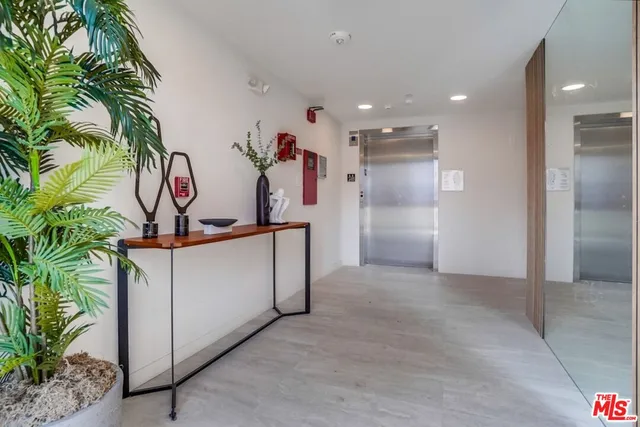 a view of a hallway with potted plants