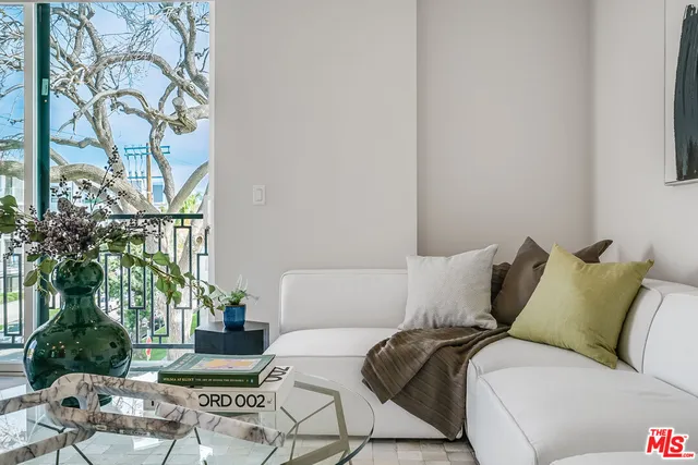 a bed room with a bed a couch and a potted plant
