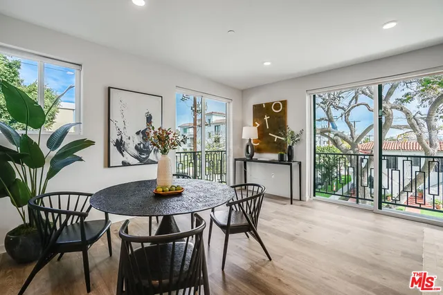 a view of a dining room with furniture large window and wooden floor