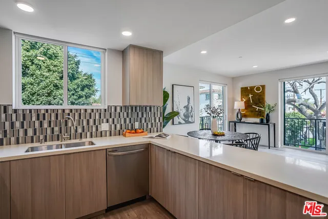 a kitchen with a sink and large window