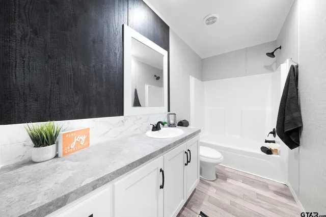 a bathroom with a double vanity sink and mirror