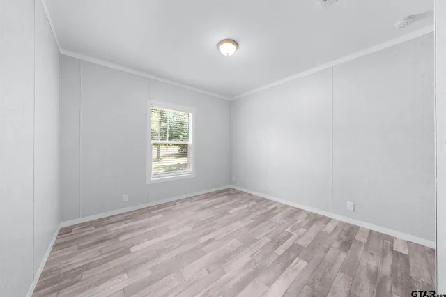a view of room with window and hardwood floor