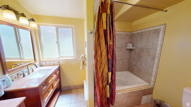 315 Abbey Road Moab, UT 84532 - Photo 23 of 46 Full bathroom featuring vanity, tiled shower / bath, and light tile patterned flooring