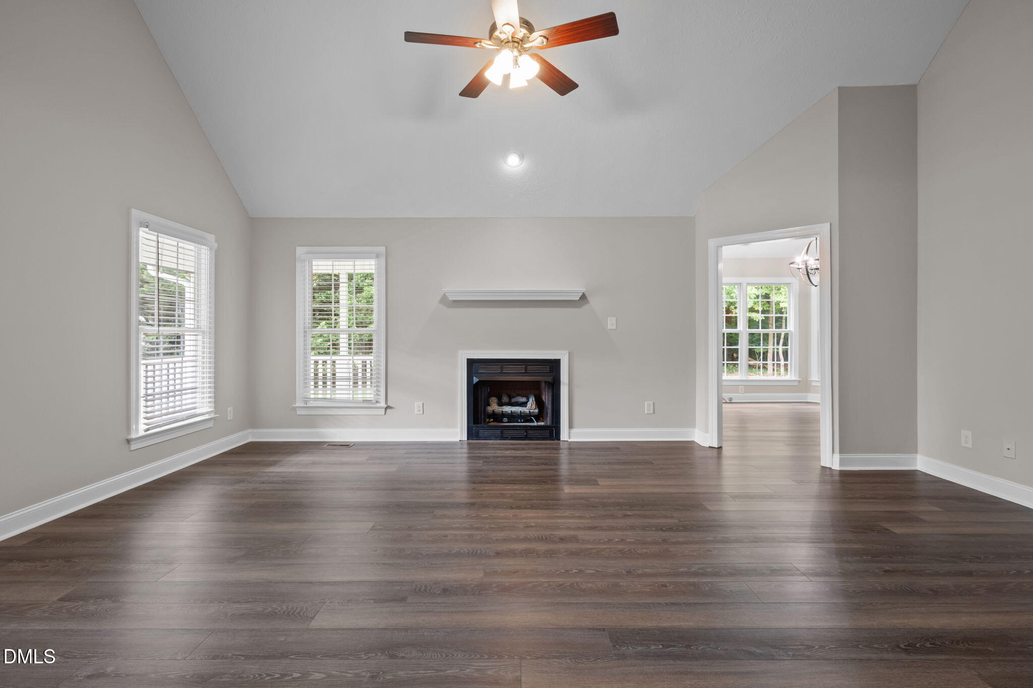 427 Fletcher Ridge Road Timberlake, NC 27583 - Photo 9 of 42 an empty room with wooden floor fireplace and windows