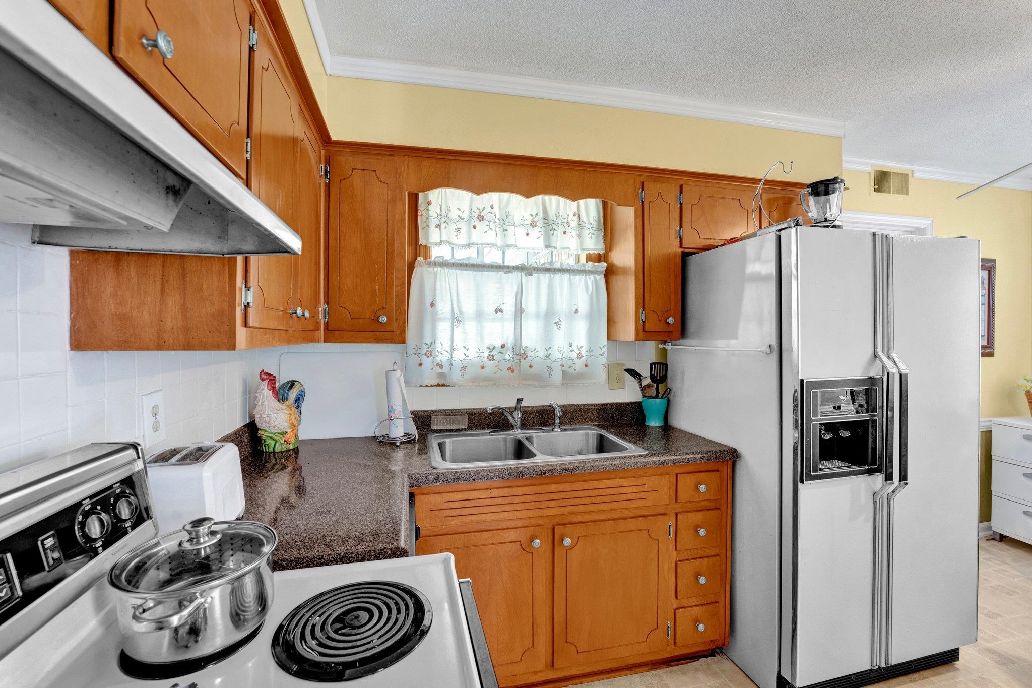 3273 Graves Road Memphis, TN 38116 - Photo 5 of 16 a kitchen with a refrigerator and a stove