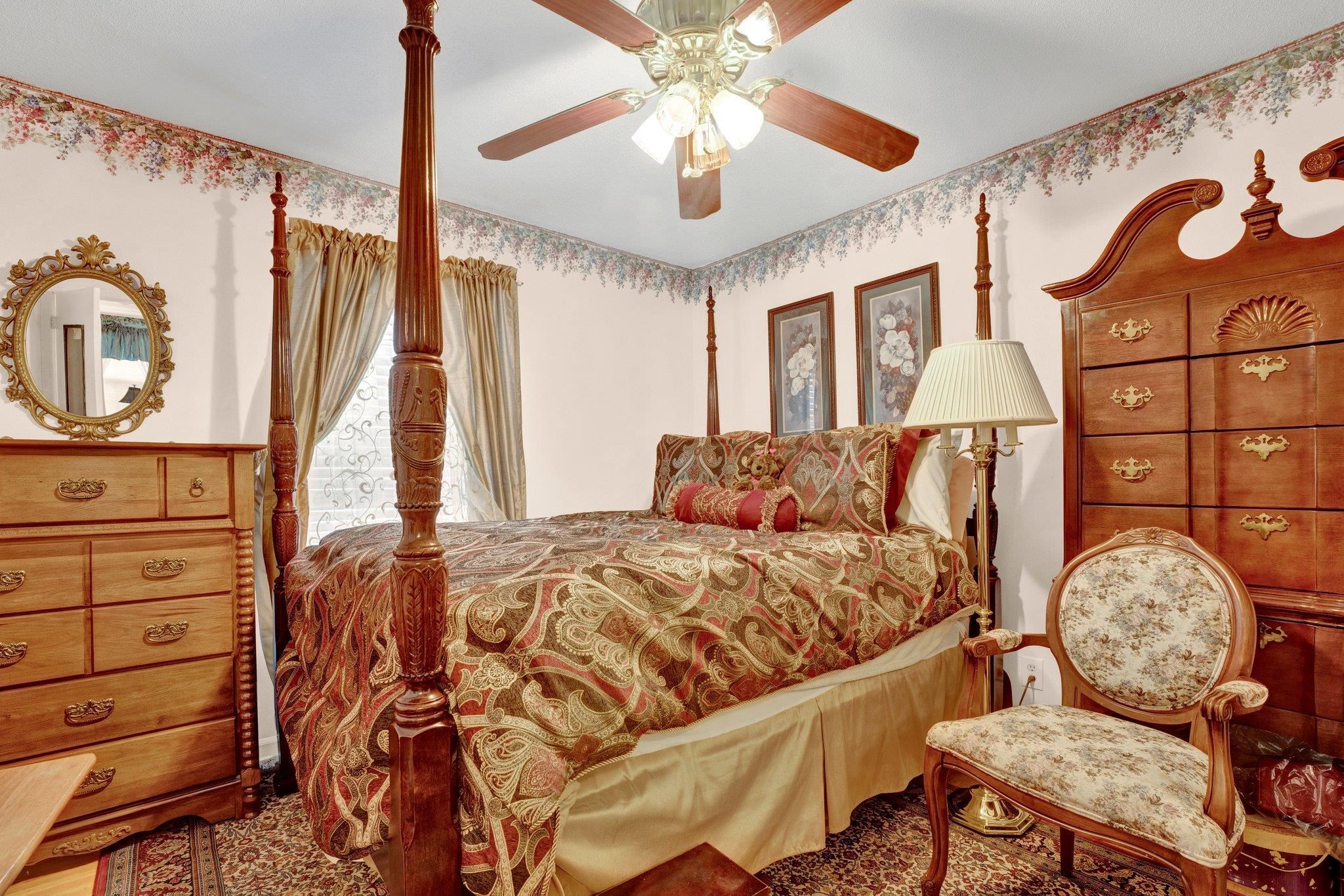 3273 Graves Road Memphis, TN 38116 - Photo 7 of 16 a bedroom with a bed mirror on dresser and a chandelier