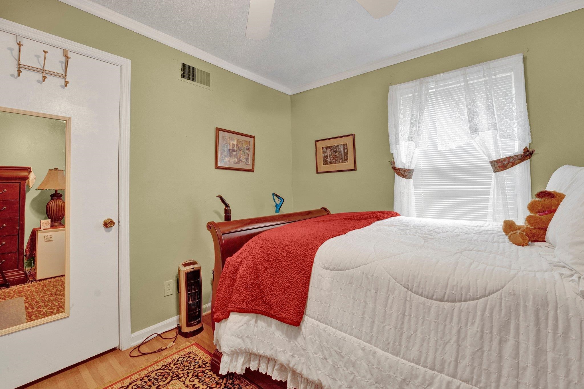 3273 Graves Road Memphis, TN 38116 - Photo 8 of 16 a bedroom with a bed and wooden floor