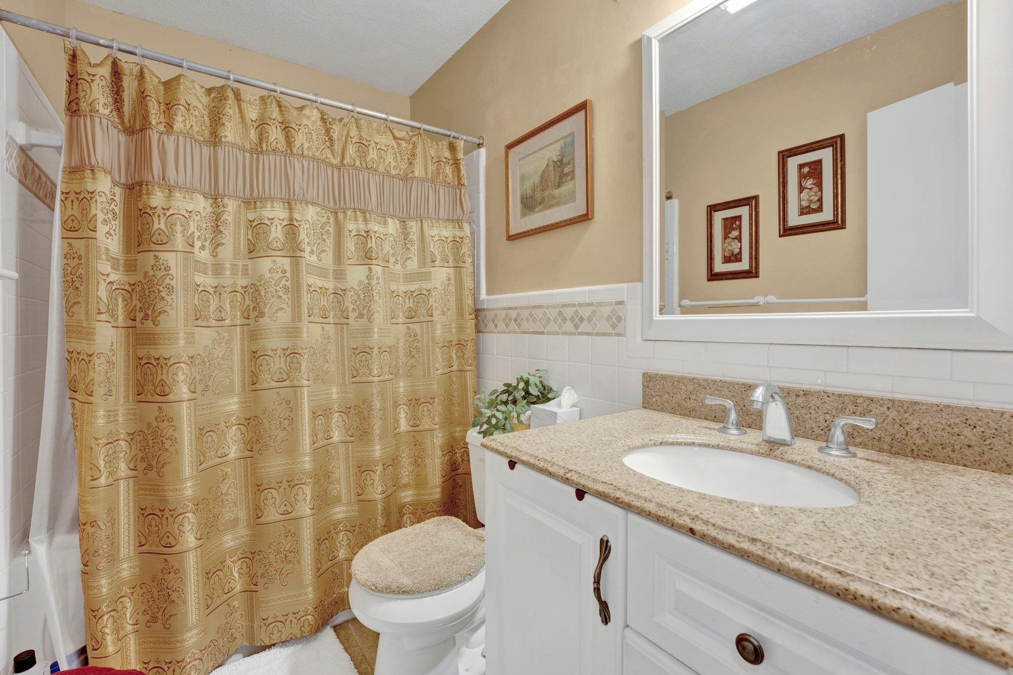 3273 Graves Road Memphis, TN 38116 - Photo 10 of 16 a bathroom with a granite countertop sink and a mirror