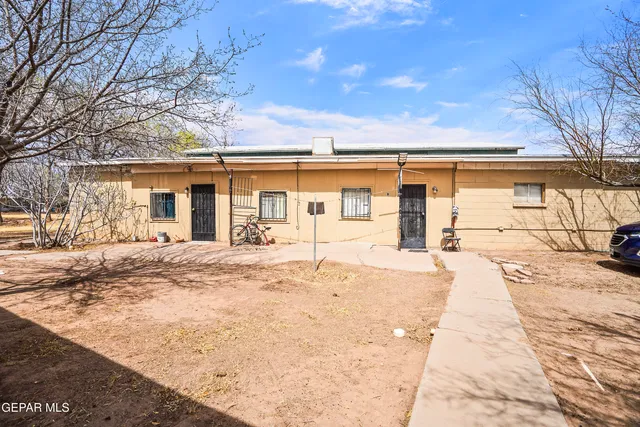 a view of a car park in front of a house