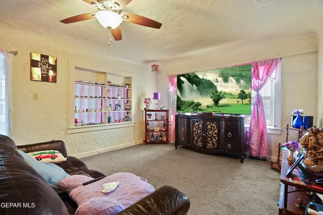 a bedroom with furniture and a flat screen tv