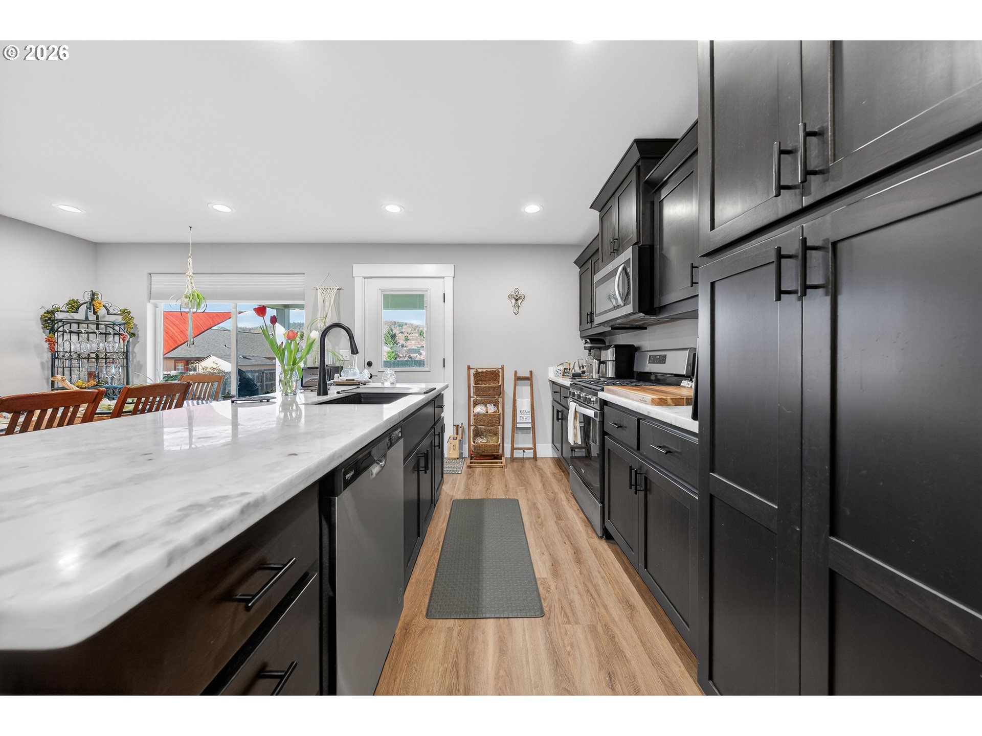 669 Northwest T Street Winston, OR 97496 - Photo 12 of 36 a kitchen with stainless steel appliances granite countertop a sink a counter top space cabinets and stainless steel appliances