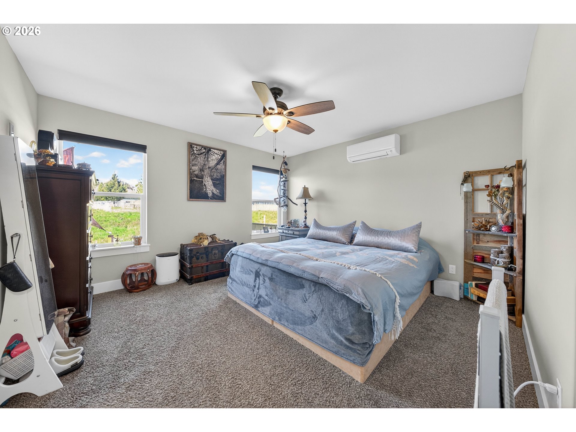 669 Northwest T Street Winston, OR 97496 - Photo 14 of 36 a spacious bedroom with a bed a couch and a chandelier