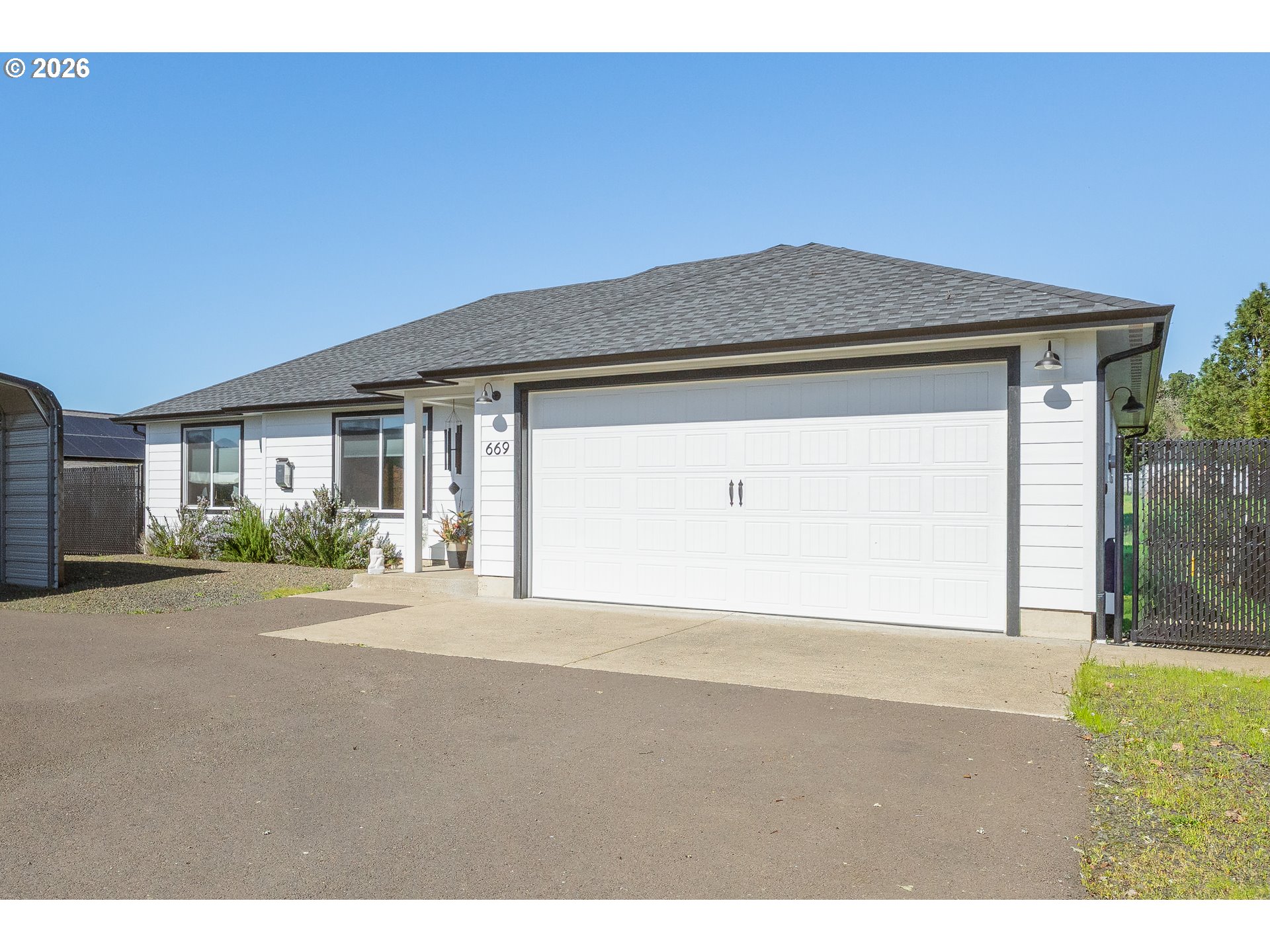 669 Northwest T Street Winston, OR 97496 - Photo 3 of 36 a front view of a house with a yard
