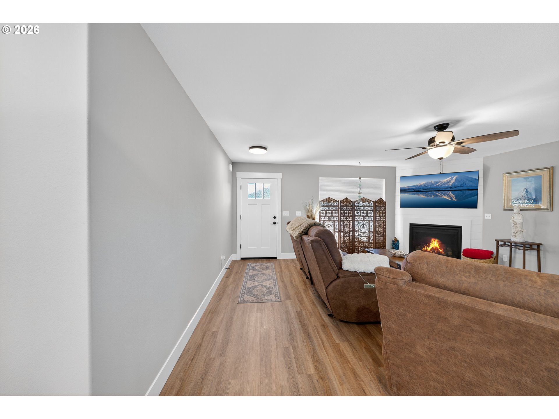 669 Northwest T Street Winston, OR 97496 - Photo 4 of 36 a living room with furniture a fireplace and a window
