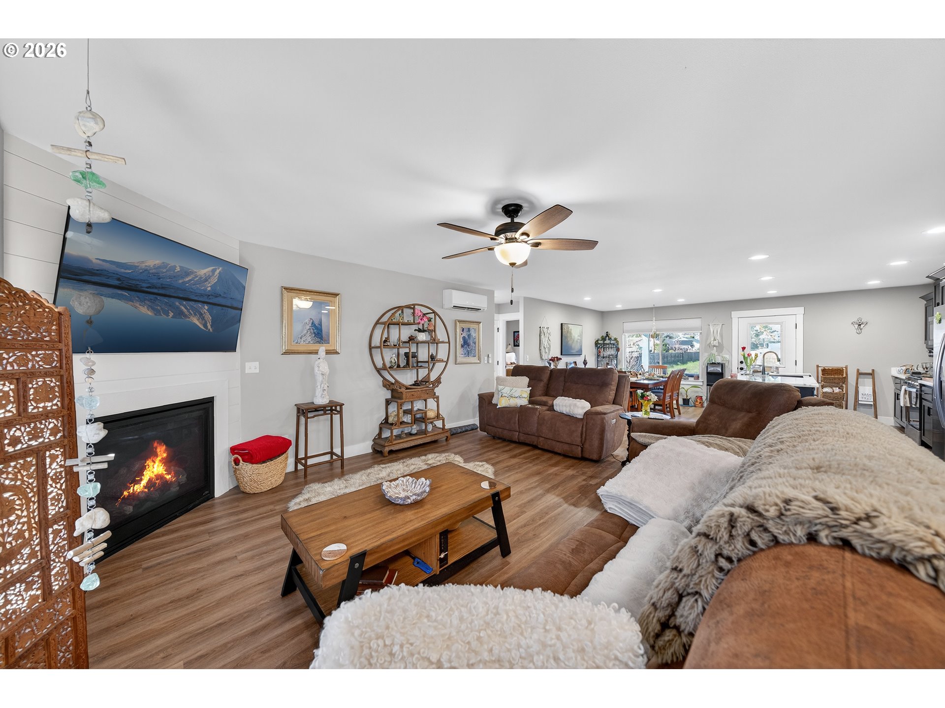 669 Northwest T Street Winston, OR 97496 - Photo 5 of 36 a living room with furniture a fireplace and a flat screen tv