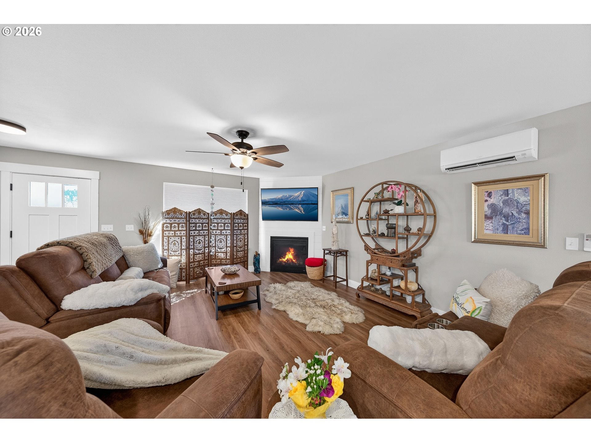 669 Northwest T Street Winston, OR 97496 - Photo 6 of 36 a living room with furniture a fireplace and a large window